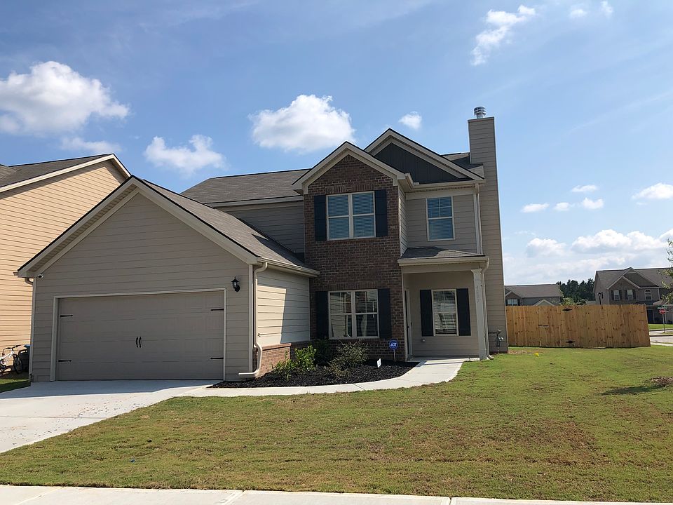 Exterior image including the garage and massive backyard.