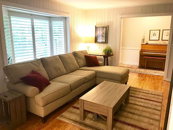 Sunny den with rock wall fireplace