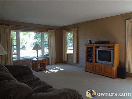 large livingroom with hardwood floor underneath carpet