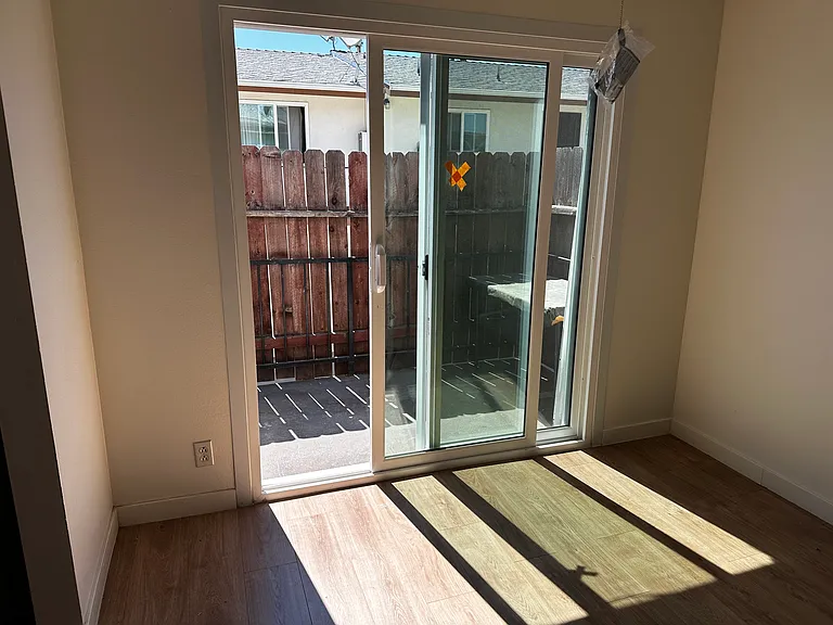 Close up of Dining room & sliding door access to 6'x12' small private balcony. Entrance to kitchen is to the left. Installed Curtains not shown in this photo. The wood patio surround has since been replaced. New photo soon. Again LOTS of Natural Light