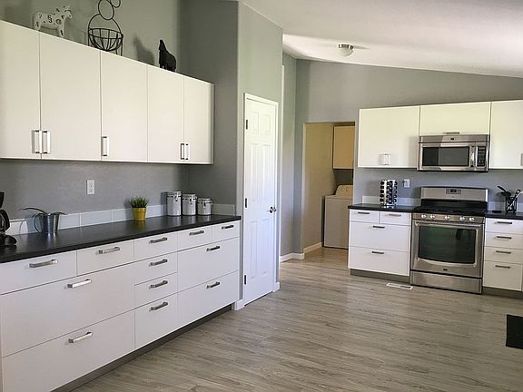 Left side of the kitchen.