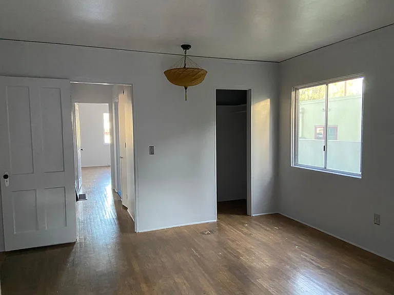 looking at the closet and out the main bedroom window