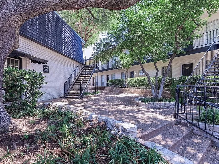 Beautifully landscaped courtyard with mature trees, shaded paths, and quiet sitting areas_perfect for peaceful outdoor moments.