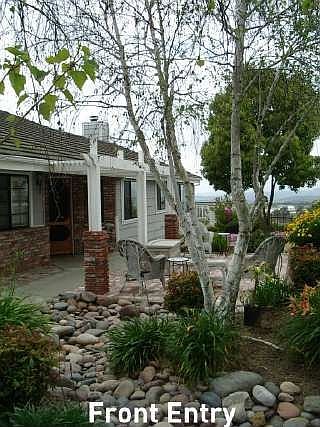 front entry with brick patio area