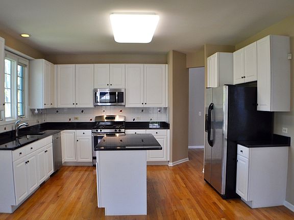 White Kitchen with granite counters and stainless appliances