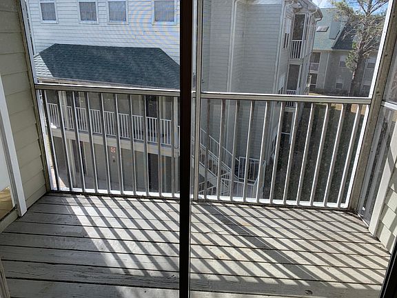 The screen porch includes a small storage space for added convenience.