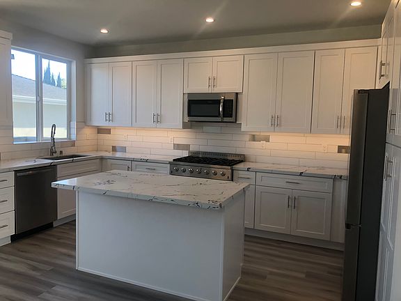 Wonderful kitchen with a a huge window over sink and walk out balcony