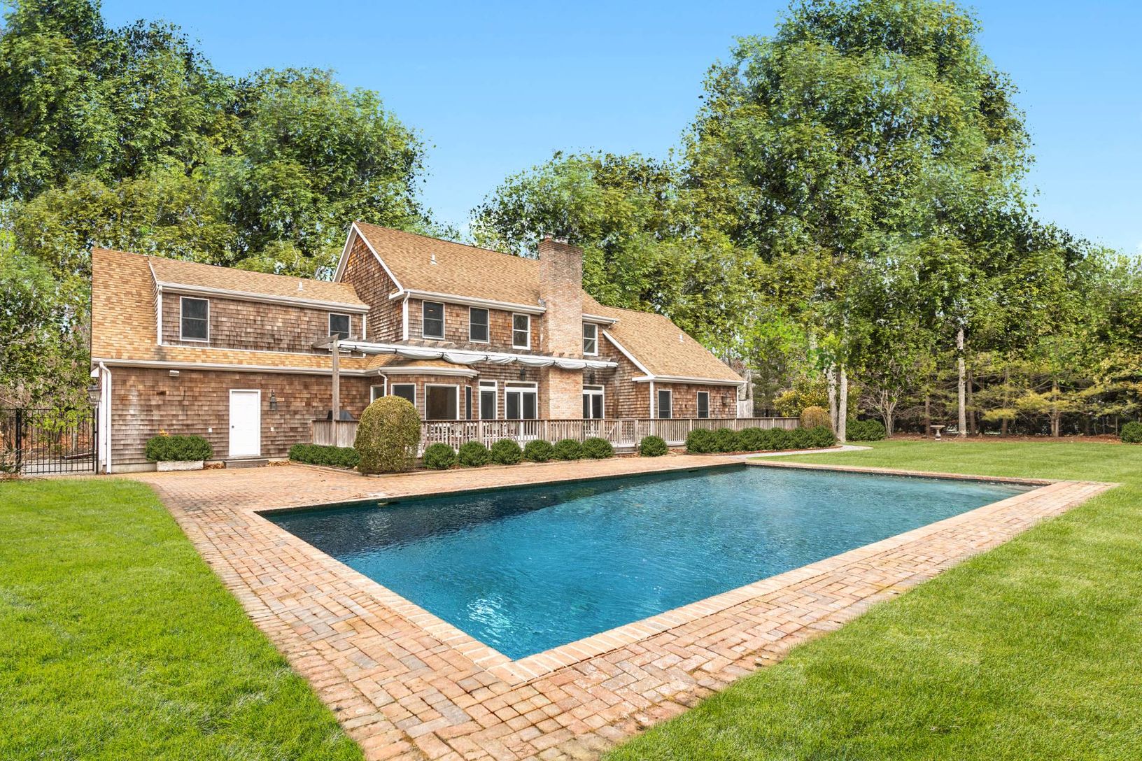  REAR OF HOME AND HEATED VINYL SWIMMING POOL