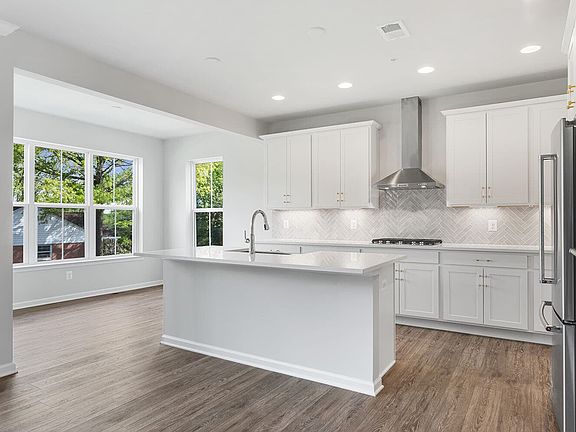 The kitchen and sunroom in the Manchester III at Bellamy by Brookfield Residential.