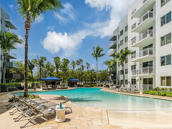 Resort-Style Pool With Lounge Chairs And Cabana