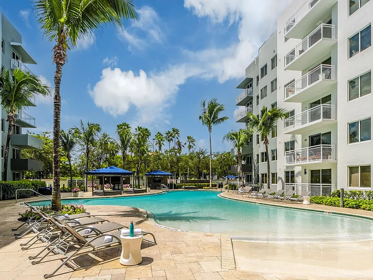 Resort-Style Pool With Lounge Chairs And Cabana