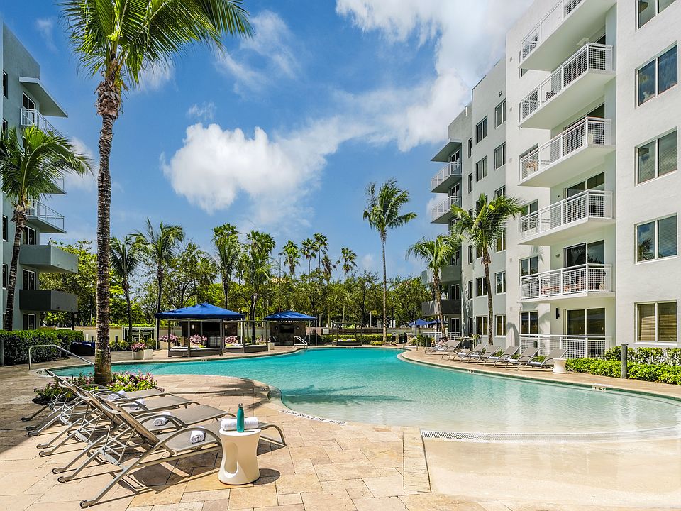 Resort-Style Pool With Lounge Chairs And Cabana