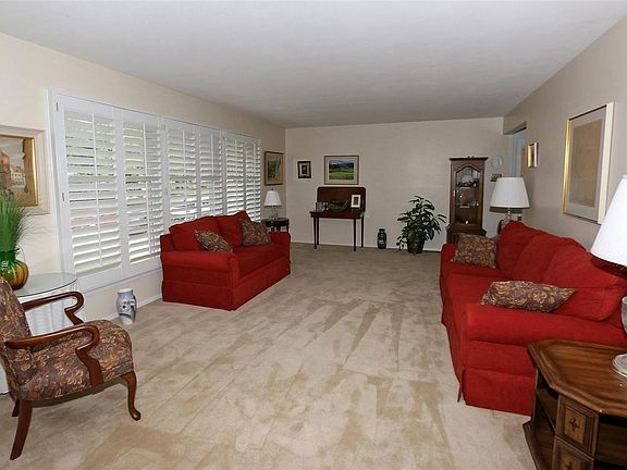 Spacious living room with lantation shutters.