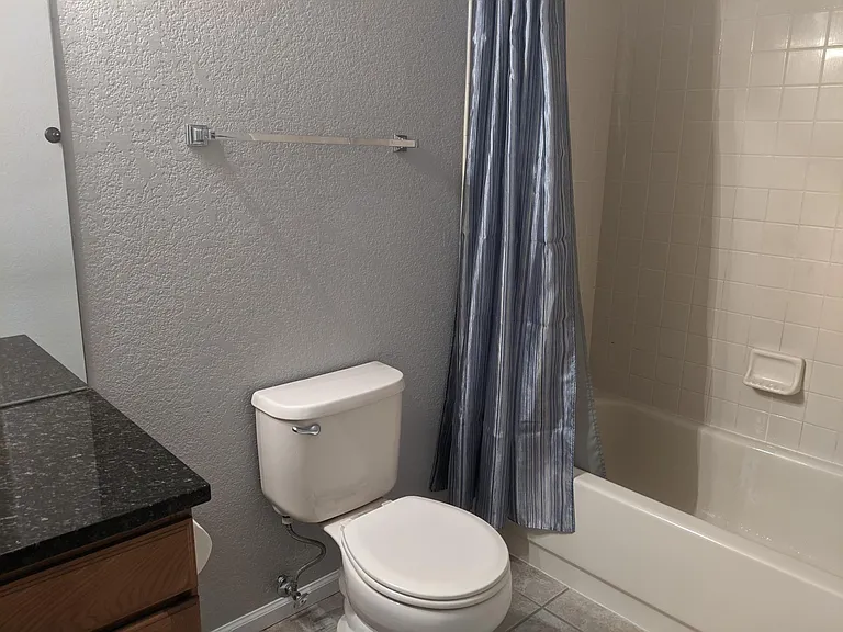 Second full bathroom on main. shower tub combo tile floor, granite vanity