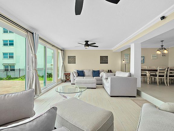 Living room with sliding glass doors to backyard and beach access