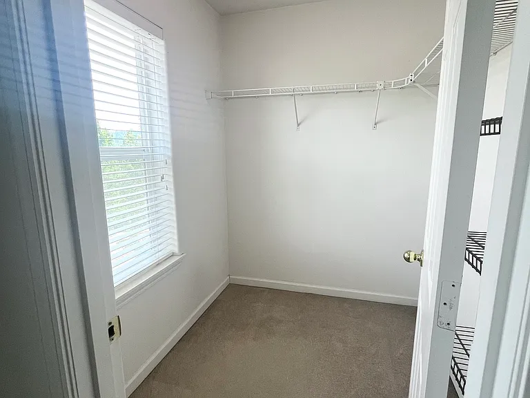Primary bedroom walk in closet