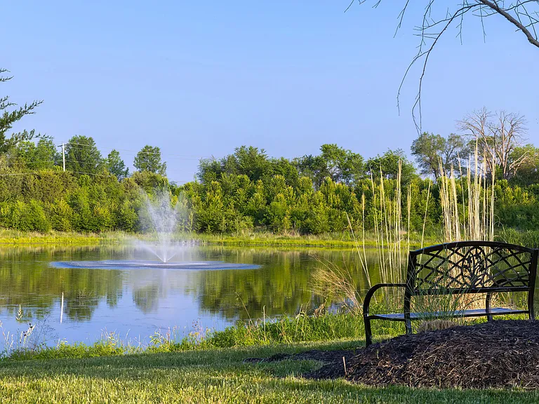 Enjoy tranquil strolls around our community lake.