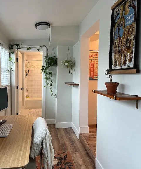 There is a small room lined with windows that can be used as an office or hobby room.