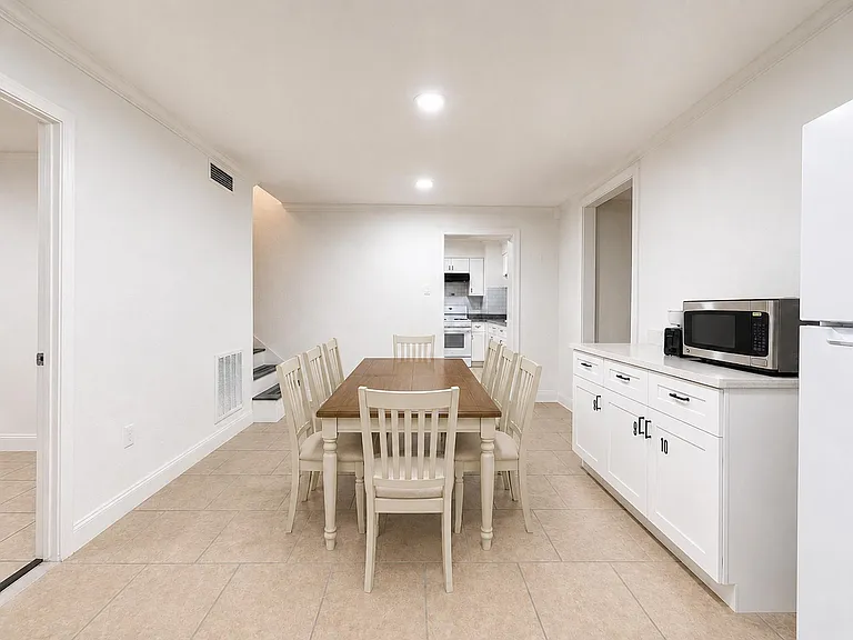 Dining area with a full-size table, microwave, toaster, coffee maker access to the adjacent kitchen