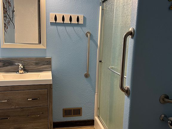 Shower stall with handrails inside and out