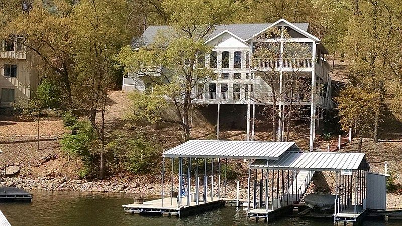 Lake view of house
						:
						Lake view showing many windows, screened in and wrap around porch&boat slip&dock