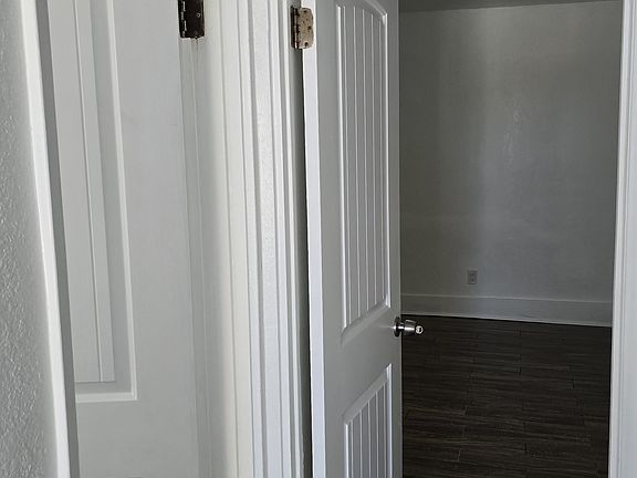 view from dining area into main bedroom and bathroom
