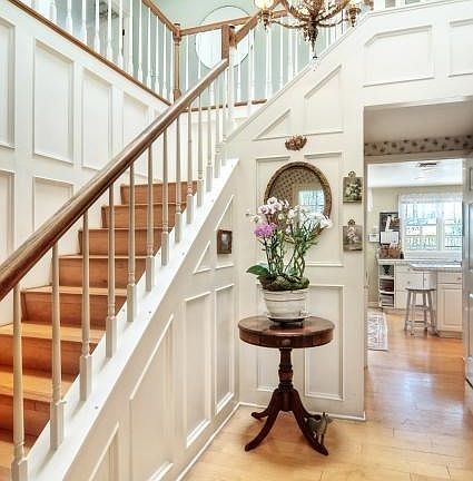 A sunny staircase in the entry leads to upstairs bedrooms.