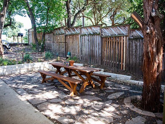 Shaded patio and yard, fenced in.