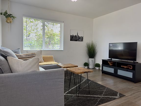Photo showing the living room furnished. Home is now vacant.