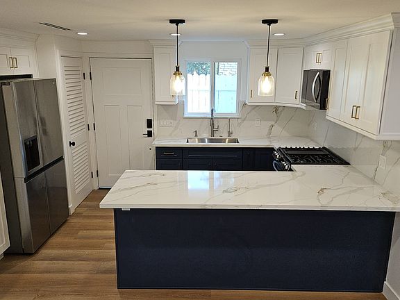 State of the art kitchen with brand new appliances, reserve osmosis drinking water filter, washer dryer tower with privacy louvered door