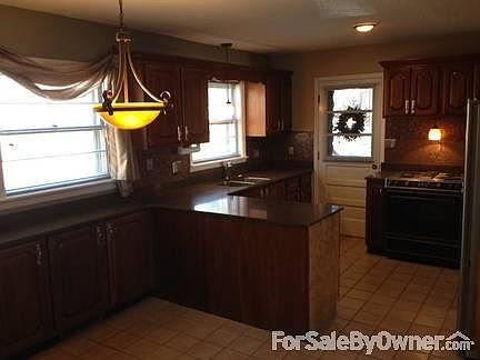 Kitchen
						:
						New quartz countertops and lighting, visible.