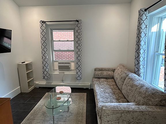 Front bedroom/living room with TV wall mount and AC unit