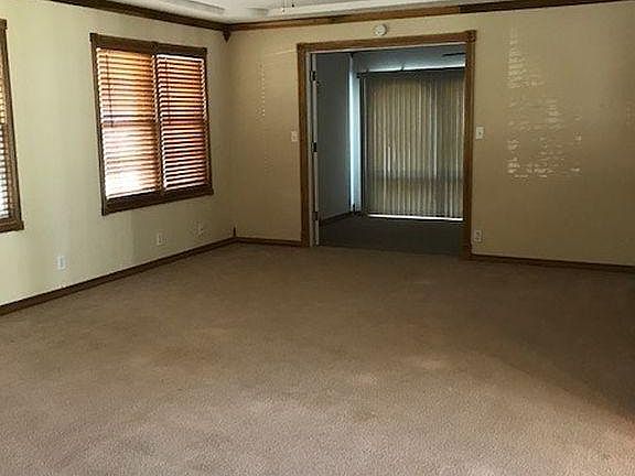 Large living space open to sun room with french doors for privacy