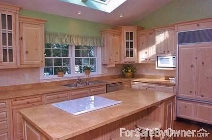 Kitchen - Custom, pickled-pine cabinets.
						:
						Efficient layout with center island. Sub-Zero refrigerator/freezer & Bosch DW.
