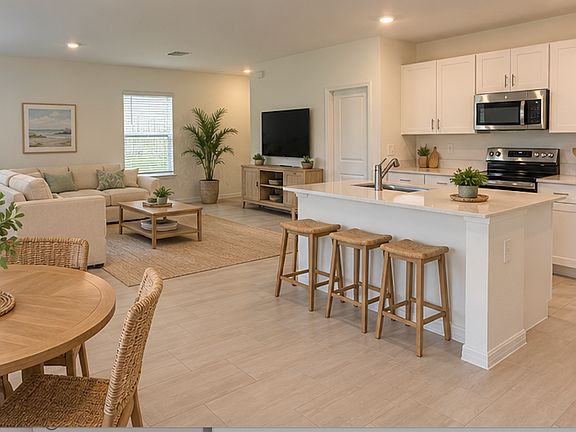 Bright, open-concept kitchen with 36" spacious cabinets, elegant quartz countertops, and a stainless steel sink with faucet and disposal. Complete stainless steel appliance package, including a refrigerator, dishwasher, microwave, and range.