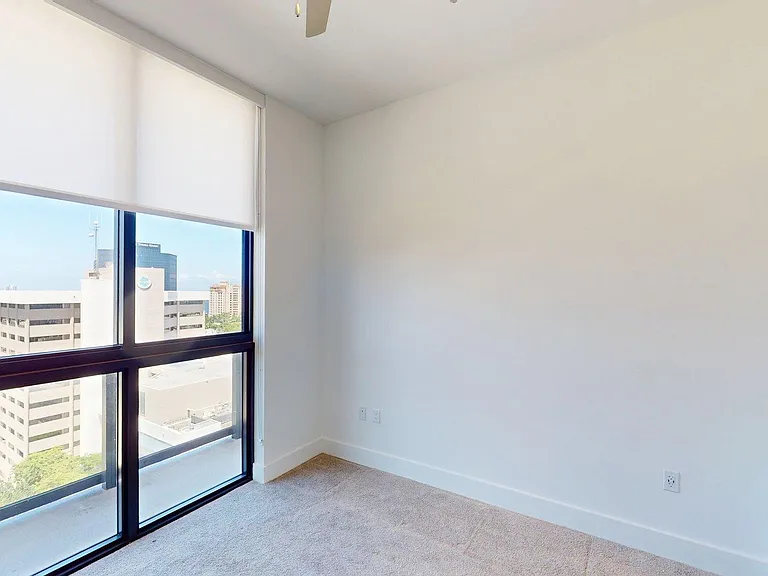 Spacious apartment Bedroom with carpet flooring.