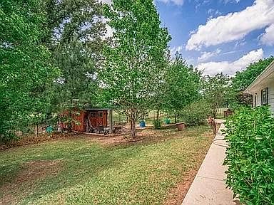 East side view of the house with storage shed with electricity