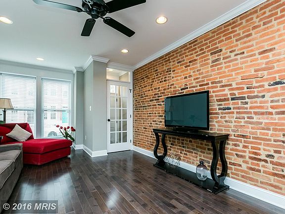 Living room offers exposed brick