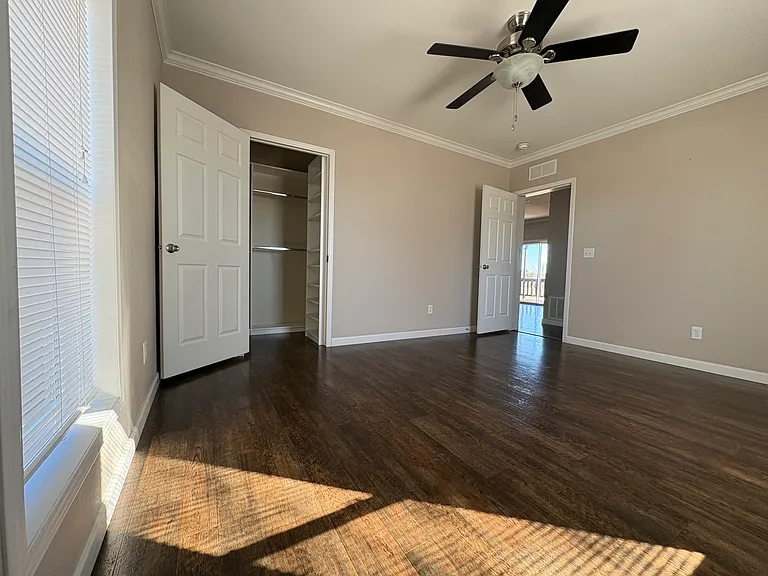 bedroom 2 with closet on left and door leading out on right