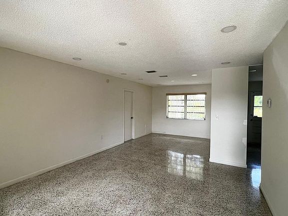 Nice size living/dining area with recessed lighting.
