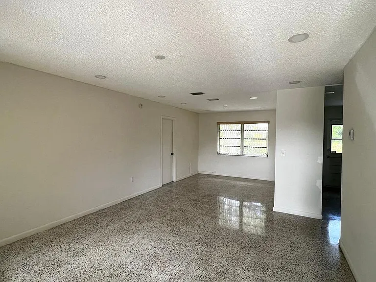 Nice size living/dining area with recessed lighting.