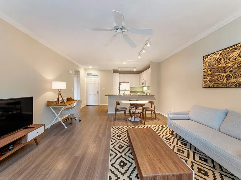 Furnished+ apartment homes come outfitted with a sofa, side chair, side table, coffee table, TV stand and 50" Television (Representative Image exact items and style of furnishings may vary)
