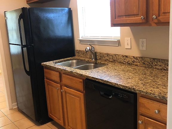 Kitchen with new dishwasher, microwave, garbage disposal, newer fridge.
