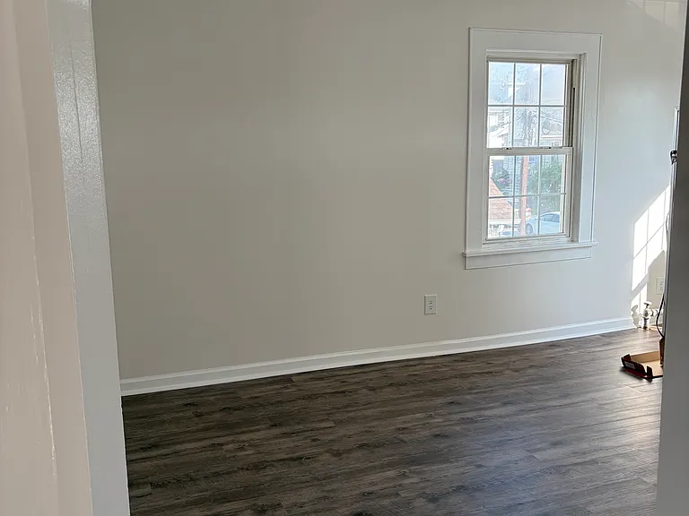 Living room, freshly painted and brand new hard wood floors.