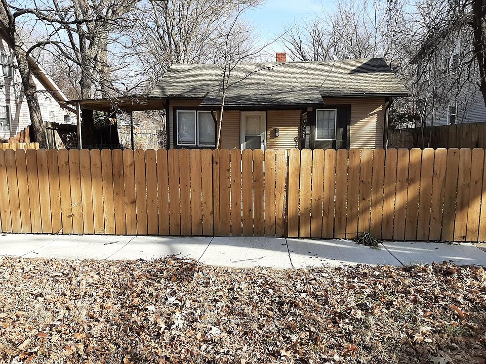 Front view of house showing covered carport on north side