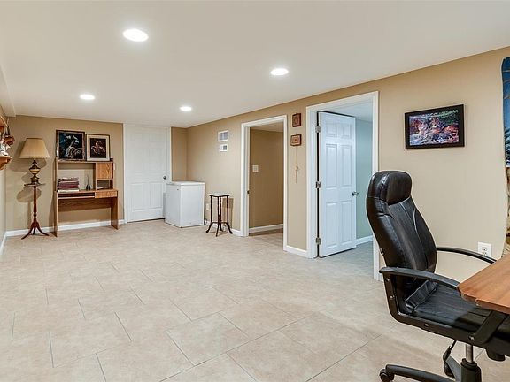 Partially finished basement with rec room, extra sleeping area, half bath, and laundry/storage room