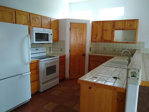 great bright galley kitchen - room for 2-3 cooks + company at adjacent breakfast bar. lots of storage, clarestory lights