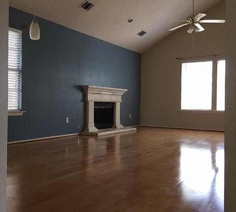 Large, open living and dining room has vaulted ceilings, ton