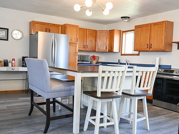 Full Kitchen with island - bar stools, chairs, and high bench for children
Upper level