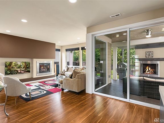 Spectacular great room w gas fireplace combining the family room, kitchen, and dining room boasting two sets of sliders that lea